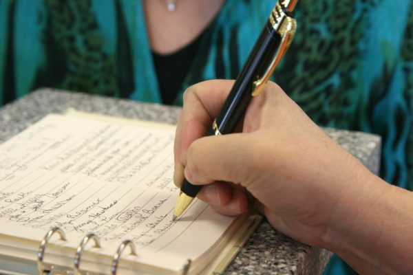 Picture of someone writing a list