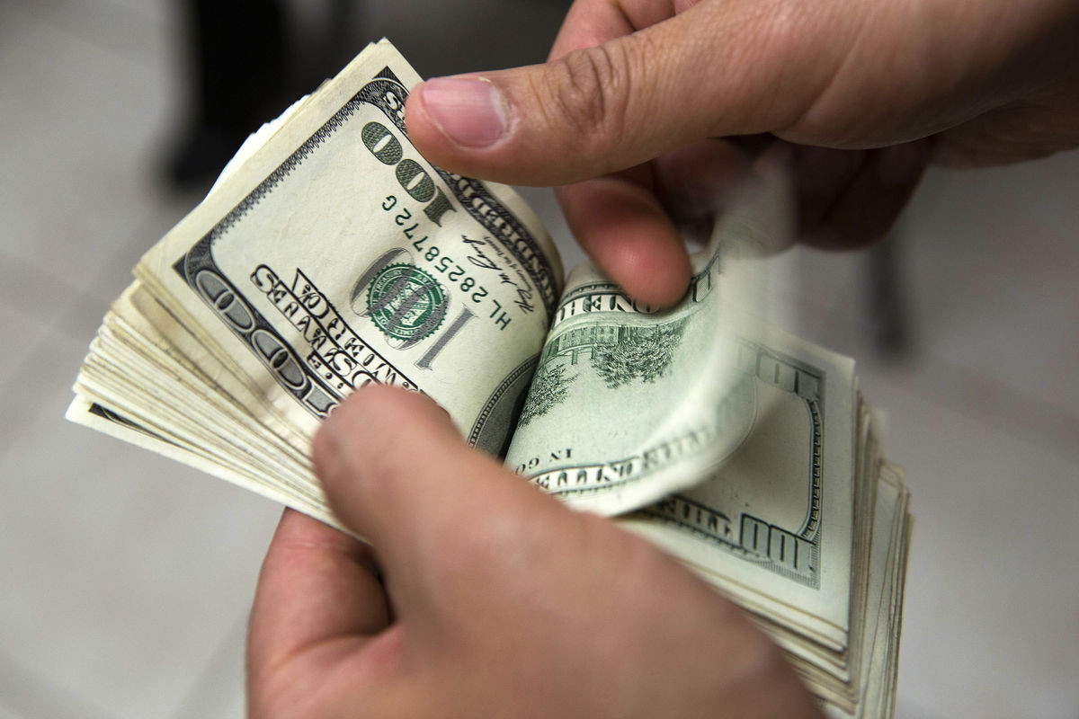 man holding had of money