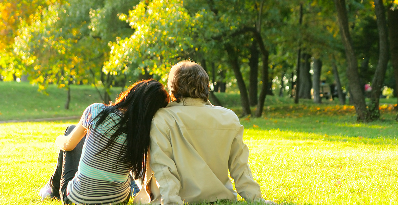 Couple sat outdoors