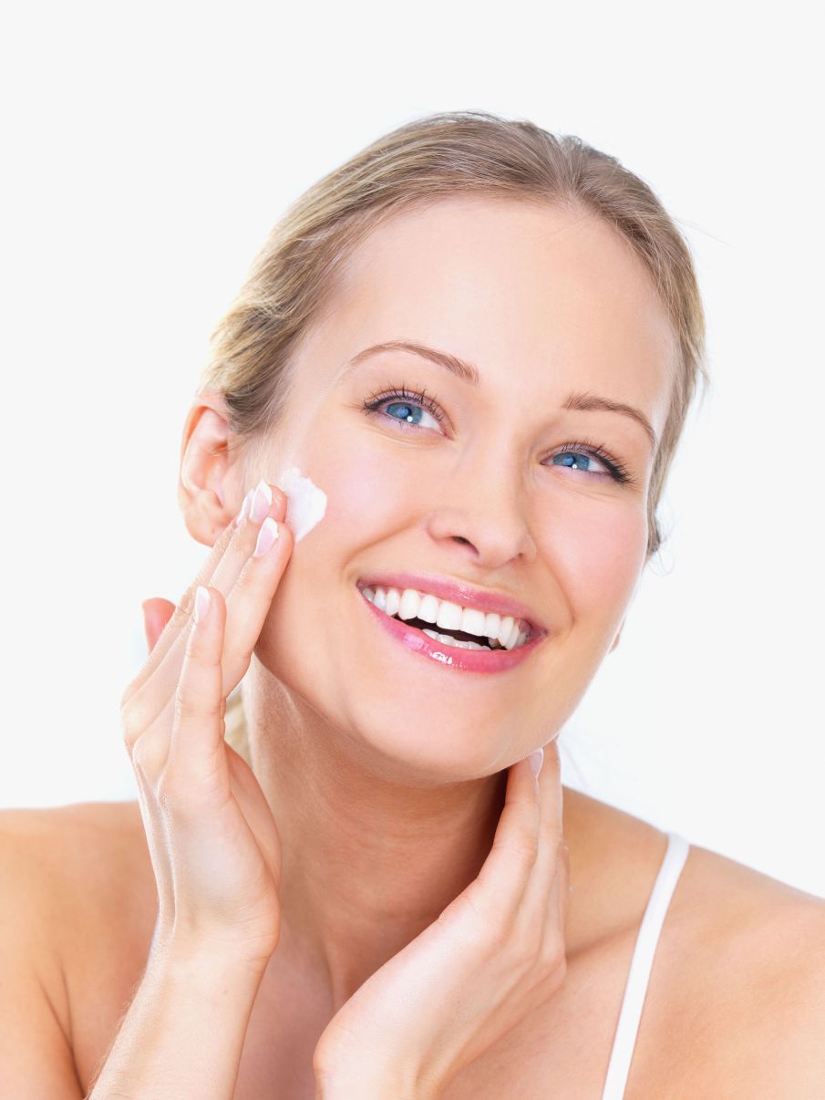 Woman applying face cream